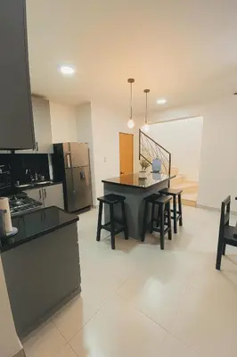 a kitchen with a table and chairs in a room at Modern 3 Bedroom Penthouse Apartment with Free Parking in San Felipe de Puerto Plata