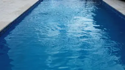 a swimming pool with blue water in it at Modern 3 Bedroom Penthouse Apartment with Free Parking in San Felipe de Puerto Plata