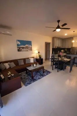 a living room with a couch and a table at Modern 3 Bedroom Penthouse Apartment with Free Parking in San Felipe de Puerto Plata