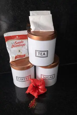 three containers of tea with a red flower in them at Modern 3 Bedroom Penthouse Apartment with Free Parking in San Felipe de Puerto Plata