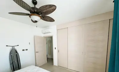 a bedroom with a ceiling fan and a closet at Beautiful Star of the Caribbean - Apartment Estrella Dominicus Bayahibe in La Laguna