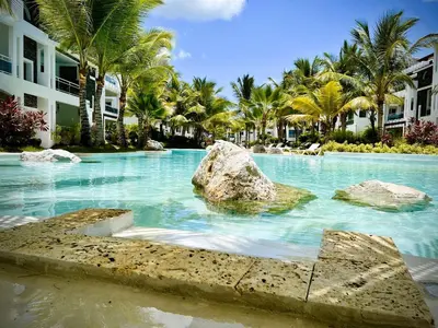 a swimming pool with a rock in the water at Beautiful Star of the Caribbean - Apartment Estrella Dominicus Bayahibe in La Laguna