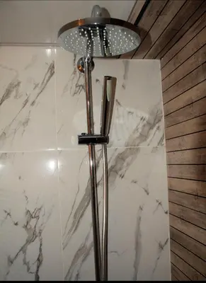 a floor lamp in a bathroom with a marble wall at Sturning Ocean View. in Santo Domingo
