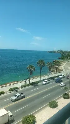 a view of a highway with cars and the ocean at Sturning Ocean View. in Santo Domingo
