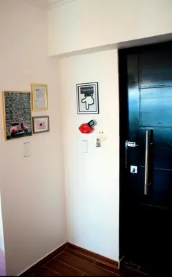 a room with a black door and pictures on the wall at Sturning Ocean View. in Santo Domingo