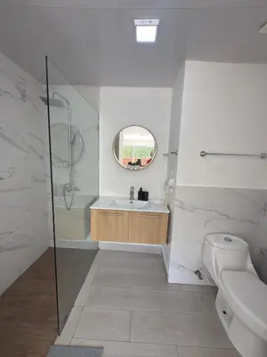 a bathroom with a shower and a sink and a toilet at Blue Coast Apartment - Vibe Dominicus in La Laguna