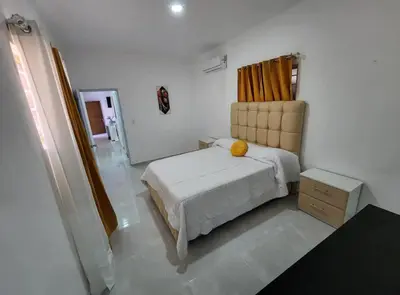 a bedroom with a bed with a yellow pillow on it at Umbrella Street, city Center, close to many atracctions in San Felipe de Puerto Plata