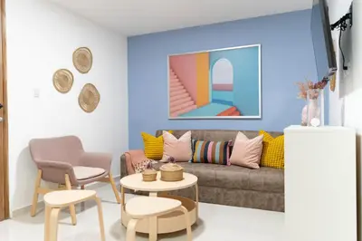 a living room with a couch and a table and chairs at LANDA MAR BOCA CHICA in Boca Chica