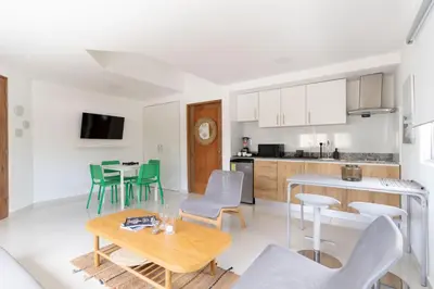 a kitchen and living room with a table and chairs at LANDA MAR BOCA CHICA in Boca Chica