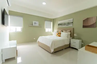 a bedroom with a bed and a television in it at LANDA MAR BOCA CHICA in Boca Chica