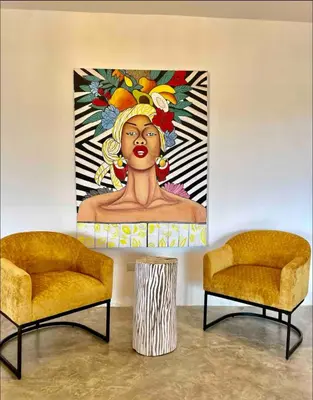 a painting of a woman on a wall with two chairs at Casa flor - 16 pax, vista al mar, 2 min de la playa in Las Galeras