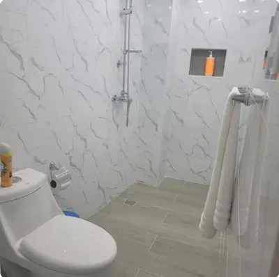 a white bathroom with a toilet and a shower at Obynb in Santo Domingo