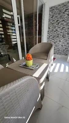 a table and chairs with a bowl of flowers on it at Obynb in Santo Domingo
