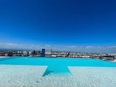 a large swimming pool with a view of a city at Bella Vista cozy-deluxe near Downtown center in Santo Domingo