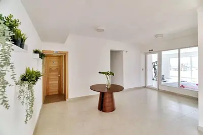 a living room with a table in the middle at Oasis Urbano Family 2br Pool Gym Lm22-8B in Santo Domingo