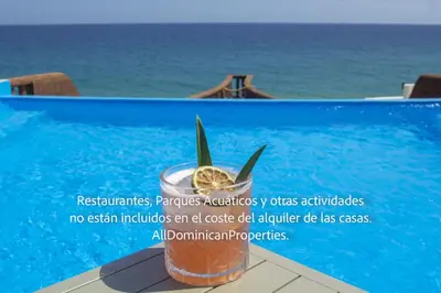 a advertisement for a drink next to a swimming pool at Ocean Villas, Campo Del Mar in Sosúa