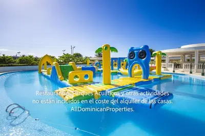 a water park with a slide in a swimming pool at Ocean Villas, Campo Del Mar in Sosúa