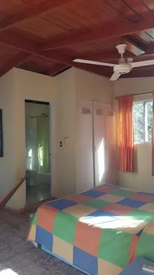 a bedroom with a colorful bed in a room at Casa Sylvie in Sosúa