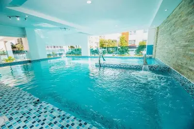 a swimming pool with blue water in a building at Stylish 1br Apt in Piantini/Serralles, Santo Dgo in Santo Domingo