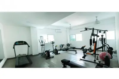 a gym with several tread machines in a room at Stylish 1br Apt in Piantini/Serralles, Santo Dgo in Santo Domingo