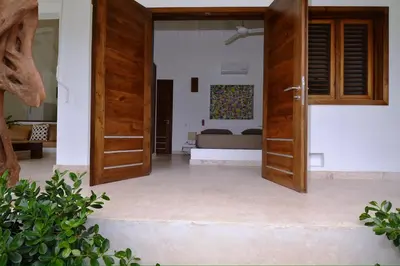 a room with a door open to a bedroom at Seaside villa with housekeeping staff - Las Terrenas in Las Terrenas