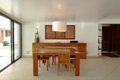a dining room with a wooden table and chairs at Seaside villa with housekeeping staff - Las Terrenas in Las Terrenas