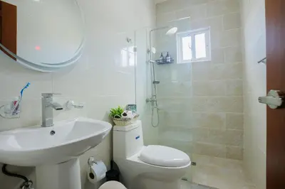 a bathroom with a toilet and a sink and a shower at Luxury Penthouse in San Francisco de Macorís