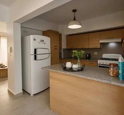 a kitchen with a white refrigerator and a counter at Luxury Riviera Colonial, Santo Domingo in Santo Domingo
