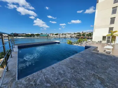 a swimming pool with a view of the water at Luxury Riviera Colonial, Santo Domingo in Santo Domingo