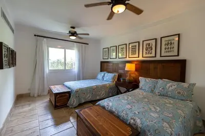 a bedroom with a bed and a couch and a window at Balcones Del Atlantic Beachfrontbbq in Las Terrenas
