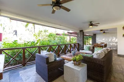 a living room with two couches and a balcony at Balcones Del Atlantic Beachfrontbbq in Las Terrenas