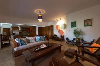 a living room with a couch and a table at Balcones Del Atlantic Beachfrontbbq in Las Terrenas