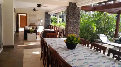 a dining room with a table and chairs at Balcones Del Atlantic Beachfrontbbq in Las Terrenas