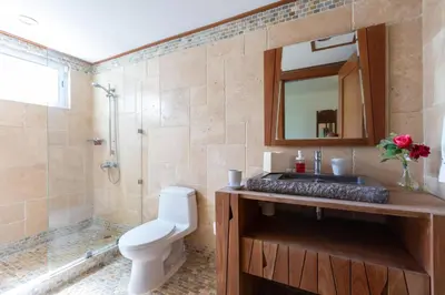 a bathroom with a toilet and a sink and a shower at Balcones Del Atlantic Beachfrontbbq in Las Terrenas