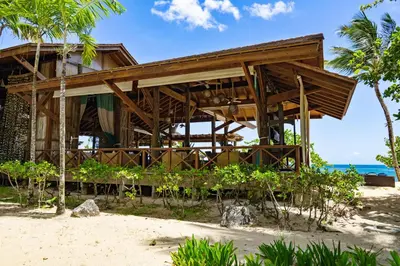 a resort on the beach with the ocean in the background at Balcones Del Atlantic Beachfrontbbq in Las Terrenas