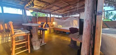 a room with a bed and a table in a room at Mini Lodge in Cabarete