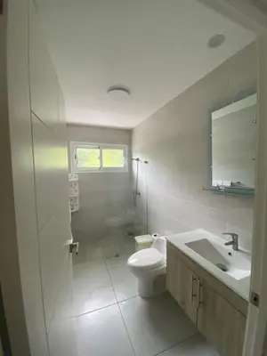 a white bathroom with a toilet and a sink at Vista Golf II Bahia Principe Playa-Nueva Romana in San Pedro de Macorís