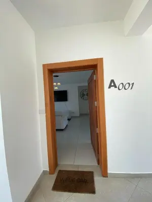 a hallway with an open door to a room at Vista Golf II Bahia Principe Playa-Nueva Romana in San Pedro de Macorís