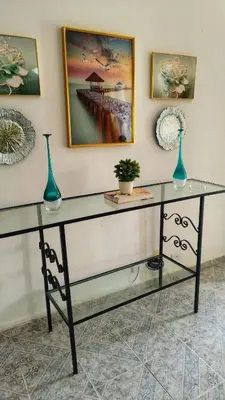 a glass desk with two vases on top of it at Camu in Camú