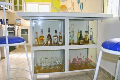 a cabinet filled with glasses and bottles of alcohol at Camu in Camú