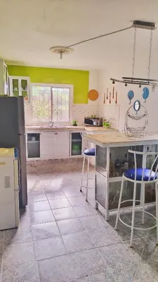 a kitchen with a counter and stools in it at Camu in Camú