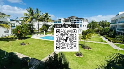 a sign in a yard in front of a villa at La Fenice Beachfront with King Beds in Las Terrenas