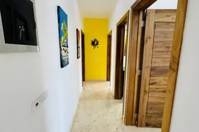 a hallway with a door and a yellow wall at La Fenice Beachfront with King Beds in Las Terrenas