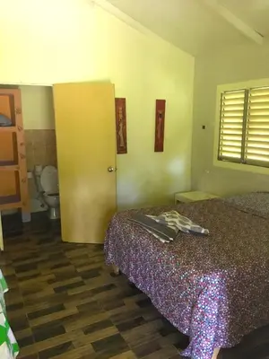 a hotel room with a bed and a bathroom at Fata Morgana Eco Hotel in Las Terrenas