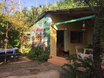 a small house with a dog standing outside of it at Fata Morgana Eco Hotel in Las Terrenas
