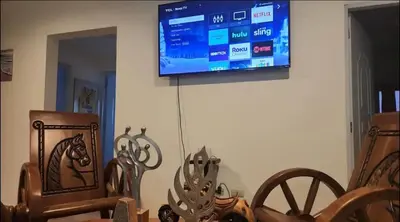 a flat screen tv hanging on a wall with wooden furniture at Casa Mami in Río San Juan