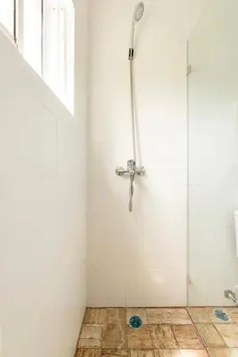 a shower stall in a bathroom with a tile floor at Casa Mami in Río San Juan