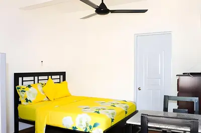 a yellow bed in a room with a ceiling fan at Apart Hotel Costa Verde#4 Exclusivo con cama Queen in Las Galeras