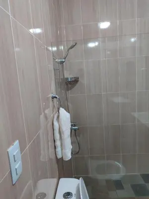 a bathroom with a shower with a toilet and towels at Apart Hotel Costa Verde#4 Exclusivo con cama Queen in Las Galeras