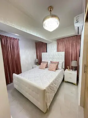 a bedroom with a large white bed with pink pillows at Torre Sophia Monserrat in Los Frailes